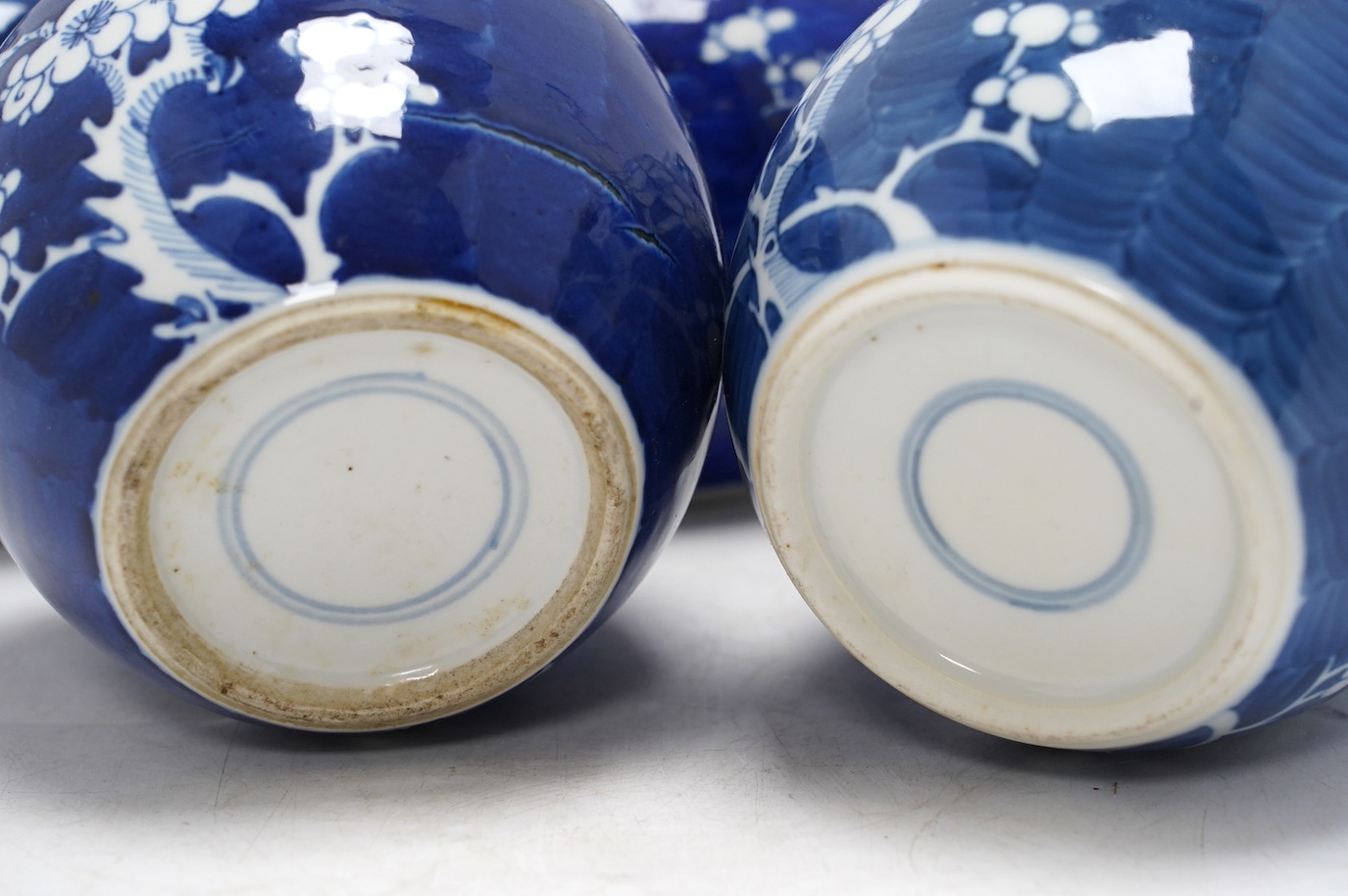 Five Chinese blue and white prunus jars, without covers, early 20th century, tallest 13cm high. Condition - one jar is chipped around the top, another has a large firing fault, the other two good